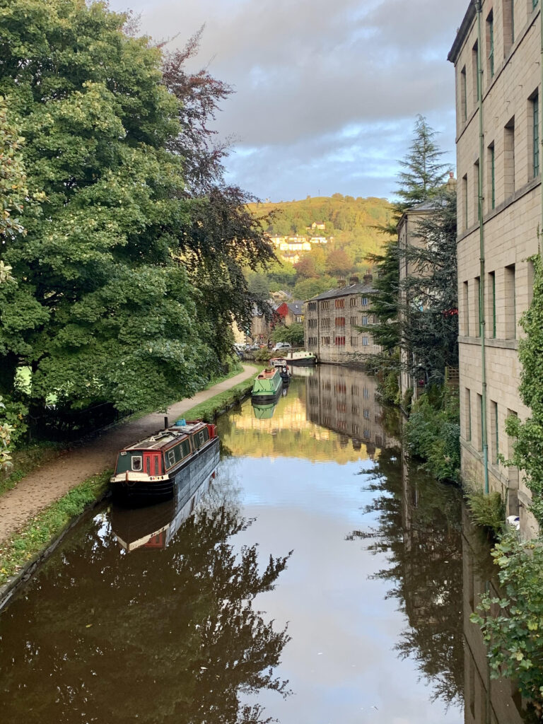 View of the canal and canal boat in Hebden Bridge in Autumn 